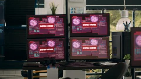 Multiple monitors with critical error message flashing on screens with hacking Stock-Fotos