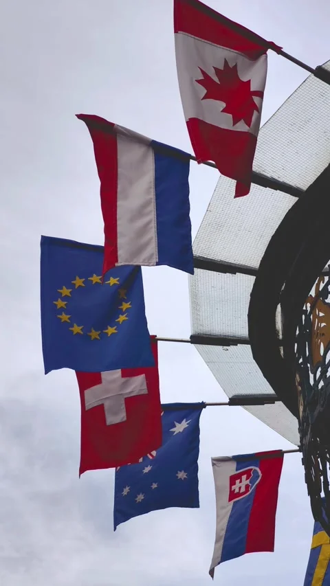 Multiple National Flags Waving in Wind Under Cloudy Sky 4K vertical 스톡 동영상 344331076