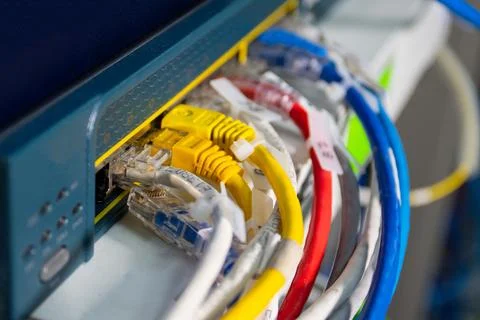 Multiple network cables connected to router or switch, showing wired intern.. Stock Photos