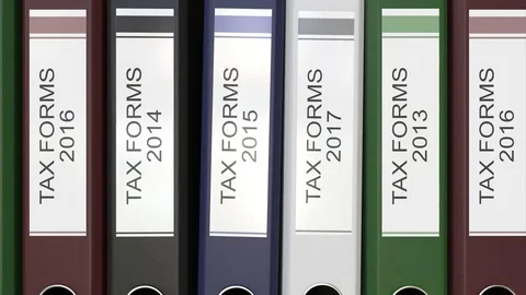 Multiple office folders with Tax forms text labels 3D rendering different years Stock Footage 74504188