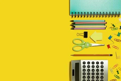 Multiple office stationary on a yellow surface Stock Photos