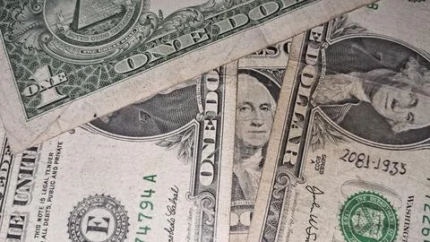 Multiple one dollar bills stacked together in a close up view Stock Photos