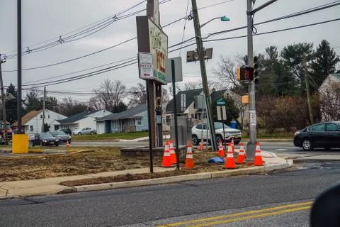 Multiple orange warning cones at a busy corner construction site Stock Photos