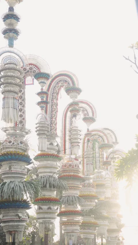 Multiple Ornate Penjor Bathed in Golden Sun Flare, Bali 4K Video Stock Footage 342384267