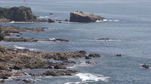 Multiple out croppings can be seen as waves surge in and out end of clip zoom Video stock 67601779