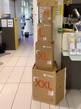 Multiple packages with Colissimo postal parcel packages with M, L, XL, XXL Stock Photos