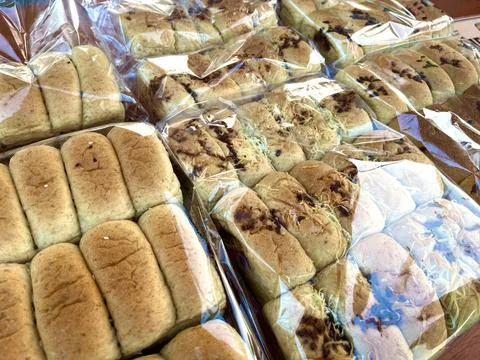 Multiple packs of soft wheat bread loaves Stock Photos