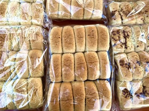 Multiple packs of soft wheat bread loaves Stock Photos