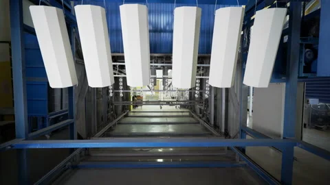 Multiple painted medical lamp frames are drying up at the factory workshop Stock Footage 220892321