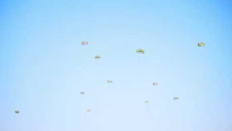 Multiple parachutes descend smoothly from the sky in a coordinated Video stock 286413519