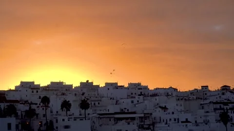 Multiple Paragliders flying doing paragliding activity over urban landscape Video stock 250405179
