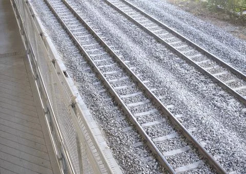 Multiple parallel train tracks disappearing into the distance over ballast Stock Photos