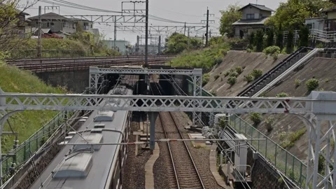 Multiple passenger trains passing over and under a bridge. Stock Footage 182671475