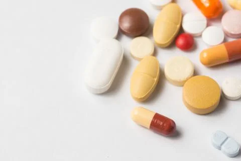 Multiple pills depicting medical treatment or pahrmaceutical industry. Stock Photos