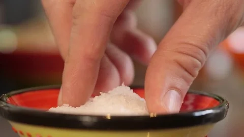 Multiple pinches of salt defocussed background 스톡 동영상 79836082