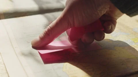 Multiple planning notes are added to an atlas while organizing a future trip to Stock Footage 337490664