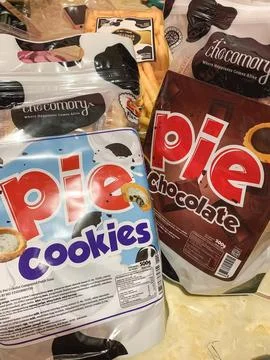 Multiple plastic packages of branded pie cookies stacked on display for ret.. Stock Photos