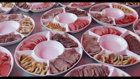 Multiple platters of sliced meats arranged for meal service, no people Stock Footage 329773201