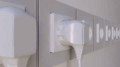 Multiple plugs being inserted into the outlets. Elecric power consumption or Stock Footage 77335082