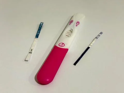 Multiple positive pregnancy tests on a white background, concept of pregnancy Stock Photos