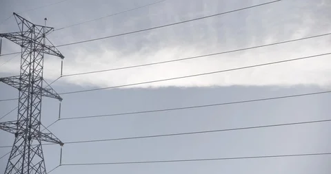 Multiple Power Lines and Towers Against Blue Sky Stock Footage 89942564