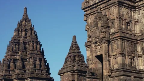 Multiple Prambanan Temple spires emerge between ornate stone structures, cr.. Stock Footage 341544090