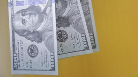 Multiple prop US dollar bills against a yellow background, ideal for financ.. Stock Photos