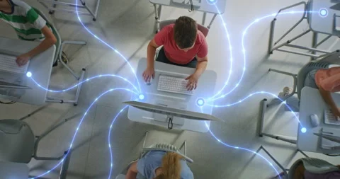 Multiple Pupils Work on Desktop Computers at Personal Tables, Visually Connected Stockbeeldmateriaal 319063668