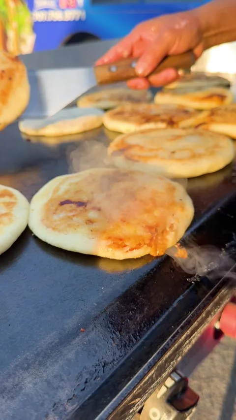 Multiple Pupusas Cooking with Steam on Griddle Stock Footage 323876278