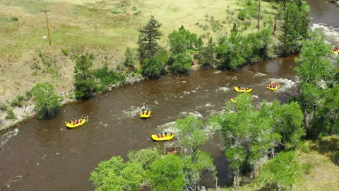 Multiple rafts float on the white water rapids of the Poudre River Stock Footage 247363889