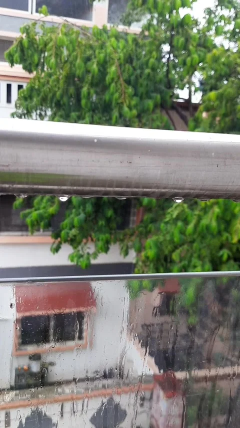 Multiple Raindrops Dripping from Metal Railing onto Glass Window Video stock 339330108