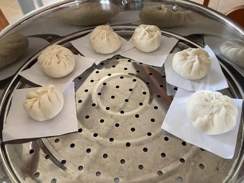 Multiple Raw Handmade Baozi Buns Arranged In Large Steamer Tray Stock Photos