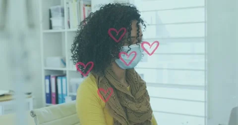 Multiple red heart icons floating over african american woman wearing face mask Stock Footage 328315246