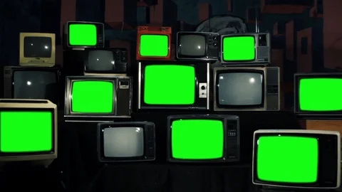 Multiple Retro TVs turning on Green Screens. Zoom Out. Iron Tone. Stock Footage 90738389