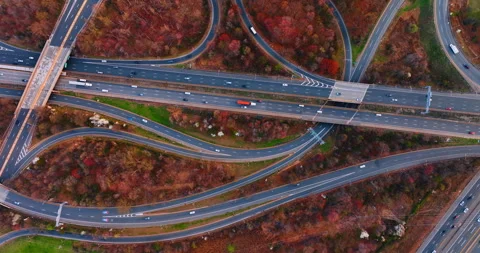 Multiple roads and highways loops cross the forests with red and brown trees. Stock Footage 334932756