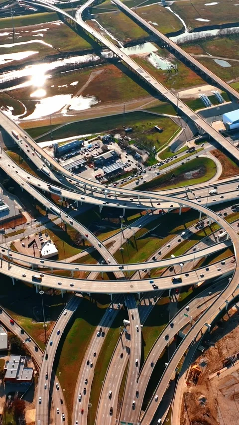 Multiple roads cross and intertwine in the urban landscape. Drone descending Stock Footage 332345901