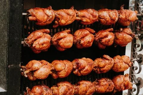 Multiple Roasted Chickens Slowly Turning On Outdoor Rotisserie Stock Photos