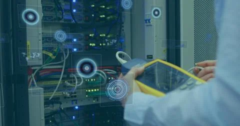 Multiple round scanners against mid section of man working in computer server Foto stock