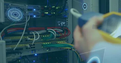 Multiple round scanners against mid section of man working in computer server Foto stock