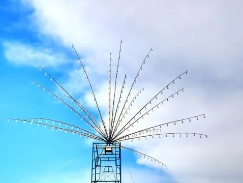 Multiple Rows of Decorative Light Bulbs Against Blue Cloudy Sky Stock Photos
