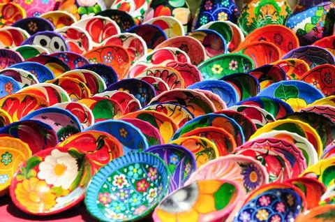 Multiple rows of multicolored hand painted saucers sold as souvenirs Stock Photos