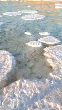 Multiple salt formations float on transparent water, offering peaceful view of Stock Photos