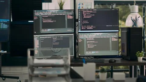 Multiple screens showing programming code in empty software it agency desk 写真素材