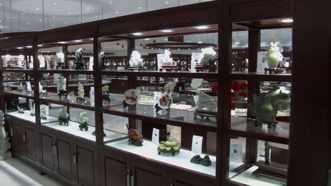 Multiple shelves of jade items in upscale Chinese shop, 4K. Stock Footage 79707887