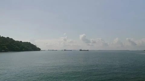 Multiple ships in the distance in the sea with clouds Video stock 220569760