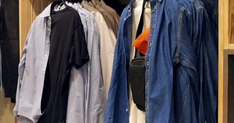 Multiple shots showcasing various shirts, a denim jacket, and a black bag Stock Footage 314466180