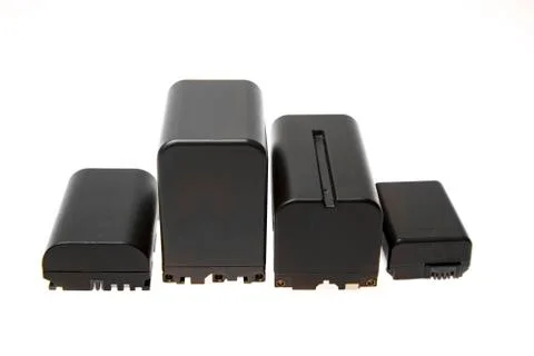 Multiple size and shape camera batteries isolated on white background Stock Photos
