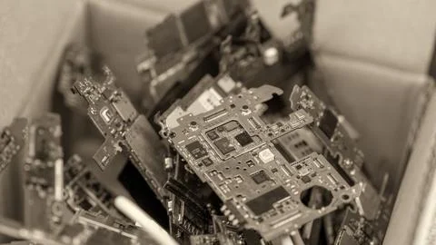 Multiple smartphone circuit boards arranged on table in electronics repair .. Stock Photos
