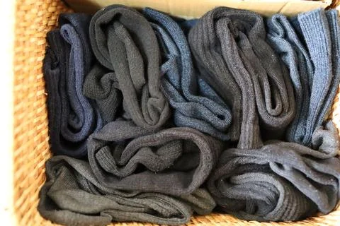 Multiple socks folded and stored in a box. Stock Photos