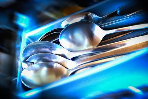 Multiple spoons neatly arranged in a kitchen drawer  top view Stock Photos